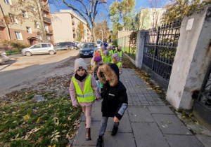 Dzieci idą parami na spacer na Pocztę