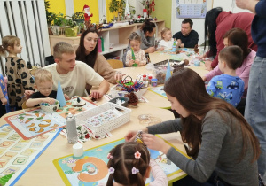 Dzieci wraz z rodzicami tworzą ozdoby świąteczne