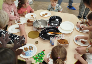 Dzieci wraz z rodzicami dekorują pierniki