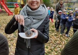 Pani dyrektor pozuje z upieczonym ziemniakiem.